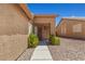 Inviting single-story home entrance with a secure gate and drought-tolerant landscaping at 7825 White Grass Ave, Las Vegas, NV 89131