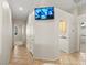 Hallway featuring tile flooring and a wall-mounted security monitoring system at 7825 White Grass Ave, Las Vegas, NV 89131
