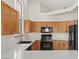 A well-lit kitchen showcasing wooden cabinets, modern appliances, and light countertops at 7825 White Grass Ave, Las Vegas, NV 89131