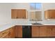 Well-maintained kitchen with wooden cabinets and modern black appliances at 7825 White Grass Ave, Las Vegas, NV 89131