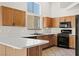 Bright kitchen featuring wood cabinets, modern appliances, and ample counter space at 7825 White Grass Ave, Las Vegas, NV 89131