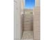 Walk-in shower featuring tiled walls, a pebbled floor, a rain shower, and body jets at 7825 White Grass Ave, Las Vegas, NV 89131