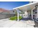 Inviting backyard featuring a covered patio, artificial grass, and playful swing set at 7849 Meandering Light Ave, Las Vegas, NV 89131