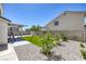 Large backyard featuring a swing set, artificial grass and rock landscaping at 7849 Meandering Light Ave, Las Vegas, NV 89131