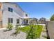 Large backyard featuring a swing set, artificial grass and rock landscaping at 7849 Meandering Light Ave, Las Vegas, NV 89131
