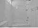 Bathroom showcases a pristine white tub, shower, and matching fixtures at 7849 Meandering Light Ave, Las Vegas, NV 89131