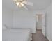 Bright bedroom featuring a ceiling fan and doorway access to a staircase at 7849 Meandering Light Ave, Las Vegas, NV 89131