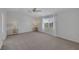 Spacious, bright bedroom with neutral carpet, ceiling fan, and a window providing natural light at 7849 Meandering Light Ave, Las Vegas, NV 89131