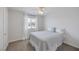Bright bedroom with a ceiling fan, cozy carpet, and a window letting in natural light at 7849 Meandering Light Ave, Las Vegas, NV 89131