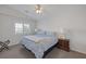 Charming bedroom with a window, side table, and patterned bedspread at 7849 Meandering Light Ave, Las Vegas, NV 89131