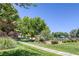 Lush community park featuring a walking path, mature trees and a playground at 7849 Meandering Light Ave, Las Vegas, NV 89131