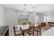 Dining area with views to backyard and modern lighting at 7849 Meandering Light Ave, Las Vegas, NV 89131