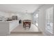 Bright dining area with a chandelier, sliding glass doors, and tile flooring adjacent to the kitchen at 7849 Meandering Light Ave, Las Vegas, NV 89131