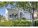 Beautiful two-story home featuring a welcoming front porch with lush, green landscaping at 7849 Meandering Light Ave, Las Vegas, NV 89131
