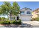 Charming two-story home with a well-manicured lawn and beautiful landscaping at 7849 Meandering Light Ave, Las Vegas, NV 89131
