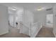 Upstairs hallway featuring white walls, carpeted floors, and doorways leading to various rooms in the home at 7849 Meandering Light Ave, Las Vegas, NV 89131