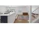 Open-concept kitchen and dining area featuring hardwood floors and modern finishes at 7849 Meandering Light Ave, Las Vegas, NV 89131