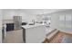 Modern kitchen with white cabinets, a large island, and stainless steel appliances at 7849 Meandering Light Ave, Las Vegas, NV 89131