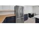 Kitchen featuring stainless steel refrigerator, butcher block counters and white cabinets at 7849 Meandering Light Ave, Las Vegas, NV 89131