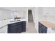 Bright open-concept kitchen with breakfast bar and view of stairway at 7849 Meandering Light Ave, Las Vegas, NV 89131