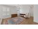 Living room with wooden floors, large rug, and shuttered windows at 7849 Meandering Light Ave, Las Vegas, NV 89131