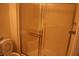 Clean bathroom with a tiled shower enclosed by glass doors, and a white toilet at 830 Carnegie St # 1011, Henderson, NV 89052