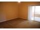 Neutral bedroom with carpet flooring and sliding glass door access to the outdoor balcony and natural light at 830 Carnegie St # 1011, Henderson, NV 89052
