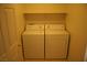 Dedicated laundry area featuring a side-by-side washer and dryer, with shelving for storage at 830 Carnegie St # 1011, Henderson, NV 89052