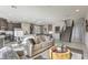 Bright, open-concept living area with modern furnishings, stainless steel appliances, and stylish staircase at 8442 Sycamore Creek St, Las Vegas, NV 89113