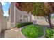 View of the backyard features a lush synthetic lawn, decorative gravel, privacy fence, and windows at 8562 Burning Bridge Ct, Las Vegas, NV 89131