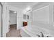Bathroom with tile floor, wood cabinets, a soaking tub, and door to the walk-in closet at 8562 Burning Bridge Ct, Las Vegas, NV 89131