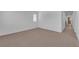 Spacious carpeted bedroom with base trim and hallway view at 8562 Burning Bridge Ct, Las Vegas, NV 89131