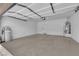 Spacious garage with white interior, ample room for parking and storage, includes water heater and water softener at 8562 Burning Bridge Ct, Las Vegas, NV 89131