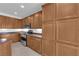 Kitchen featuring abundant wooden cabinets, stainless steel appliances, and tile flooring at 8562 Burning Bridge Ct, Las Vegas, NV 89131