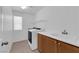 Bright laundry room features modern appliances, storage cabinets, and a convenient utility sink at 8562 Burning Bridge Ct, Las Vegas, NV 89131