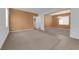 Open-concept living room with plush carpet and bright natural light at 8562 Burning Bridge Ct, Las Vegas, NV 89131