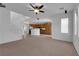 Open-concept living area with staircase, neutral carpet, and view into the adjacent kitchen at 8562 Burning Bridge Ct, Las Vegas, NV 89131