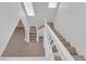 Carpeted staircase with white banister that spans two floors at 8562 Burning Bridge Ct, Las Vegas, NV 89131