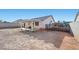 Exterior view of the home from the backyard with covered patio and block wall at 905 Harp Way, North Las Vegas, NV 89032