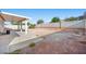 Large backyard with covered patio and block wall, offering ample space for outdoor activities at 905 Harp Way, North Las Vegas, NV 89032
