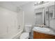 Bathroom with a shower-tub combo, granite countertop vanity, and modern fixtures at 905 Harp Way, North Las Vegas, NV 89032