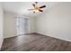 Sunlit bedroom with new flooring, vertical blinds and ceiling fan at 905 Harp Way, North Las Vegas, NV 89032