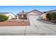 Charming single-story home featuring a two-car garage and desert landscaping for easy maintenance at 905 Harp Way, North Las Vegas, NV 89032