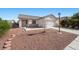 Single-story home with xeriscaping, a covered entryway, and attached two car garage at 905 Harp Way, North Las Vegas, NV 89032