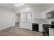 White kitchen has stainless sink, dishwasher, and countertop, and features black appliances at 905 Harp Way, North Las Vegas, NV 89032