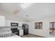 Bright kitchen featuring white cabinets, black appliances, modern countertops, and a window for natural light at 905 Harp Way, North Las Vegas, NV 89032
