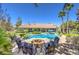 Expansive backyard with pool, fire pit, covered patios, lush landscaping, and a putting green at 9135 Hickam Ave, Las Vegas, NV 89129