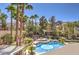 Overhead view of a backyard featuring a pool, spa, lush greenery, and a fire pit at 9135 Hickam Ave, Las Vegas, NV 89129