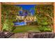 Lush backyard featuring a sparkling pool, mature trees, and inviting lounge area at 9135 Hickam Ave, Las Vegas, NV 89129