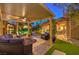 Beautifully landscaped backyard with a covered patio, pergola, and elegant spiral staircase at 9135 Hickam Ave, Las Vegas, NV 89129